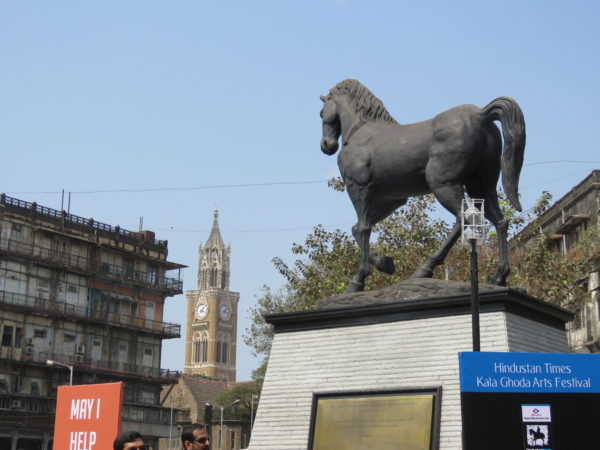 New Statue installed in 2017 as symbol of Kalaghoda. Watson Hotel & Rajabhai Tower in background.